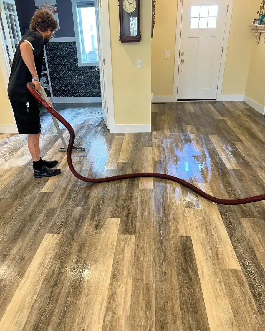 An Adaptive Cleaning Solutions technician deep cleaning a vinyl plank floor