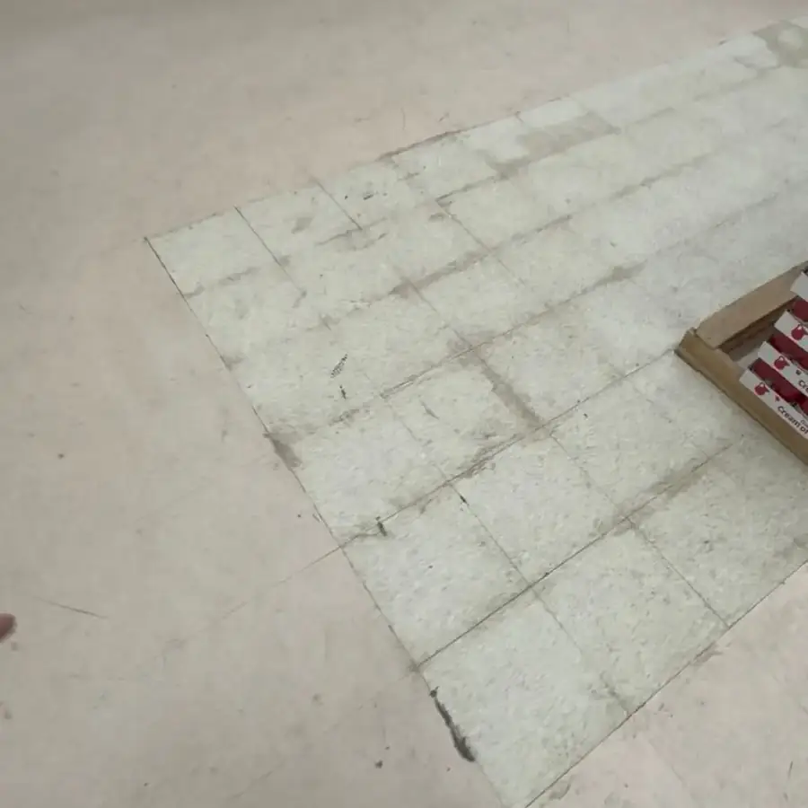 Before: dull, scuffed, and stained floor tiles in a grocery store