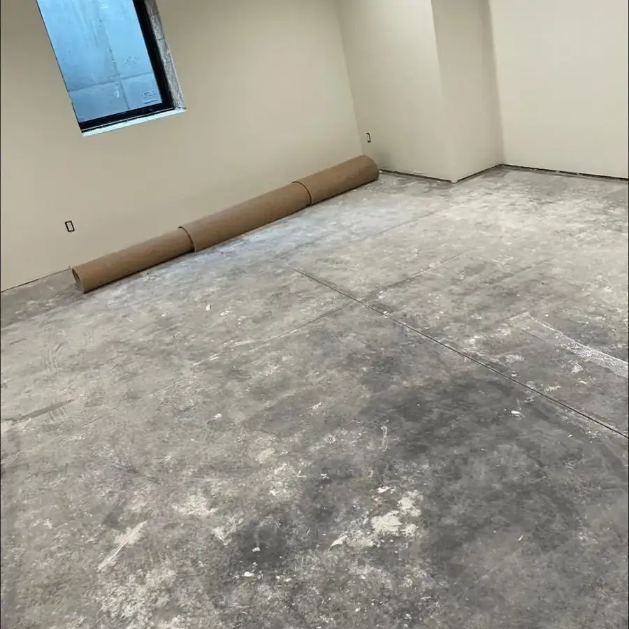 Before: dusty, debris-covered bare concrete floor